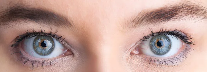 A close up photo of a woman's eyes. They are light blue.